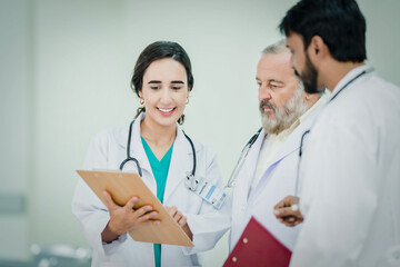 Fototapeta premium Professional Medical Doctors and team discussing in clinic hall, healthcare professionals having discussion in hospital corridor.