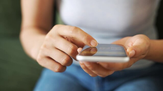 Finger of woman touching scroll page app on mobile phone.