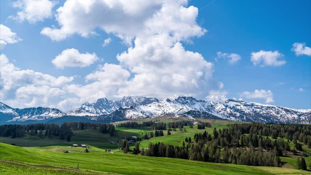 Timelapse video of clouds moving over rugged mountains and wide alpine meadows. Rosszähne / seen from Seiser Alm (Alpe di Siusi) in the Dolomites, South Tyrol, Italy.