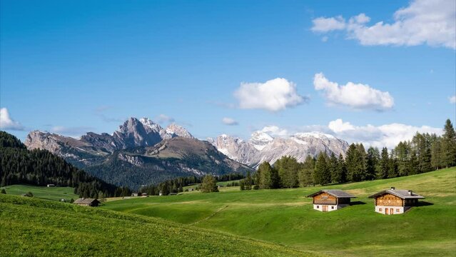 Timelapse video of passing clouds with alpine landscape of the Seiser Alm (Alpe di Siusi) in the Dolomites. The Puez-Geisler mountain range dominates the stunning landscape.