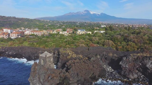 Torre Saracena old tower and Etna, Santa Tecla, Catania, Sicily, Italy