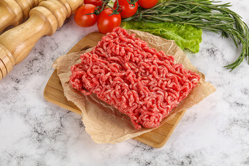 Raw minced beef meat on cutting board