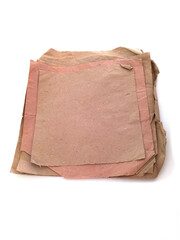 Bunch of recycled papers of various sizes and colors isolated. Pieces of packing paper on white background. Card boards and crafts concept.