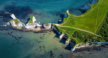 High aerial top view of the Old Harry Rocks headland, Jurrasic Coast, Dorset, England, during a sunny spring day
