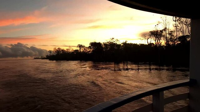 amazon river in amazon rainforest Brazil waling at sunset