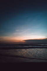 Amazing sunset dark blue sky on the Indian Ocean with waves on Bali island