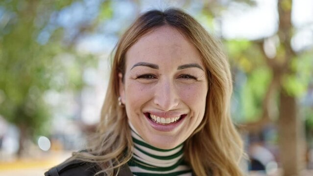 Young beautiful hispanic woman smiling confident at park