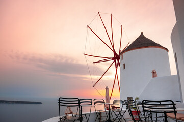 Famous windmill at sunset in Santorini island, Greece.