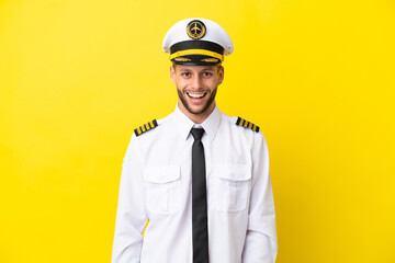 Airplane caucasian pilot isolated on yellow background with surprise facial expression