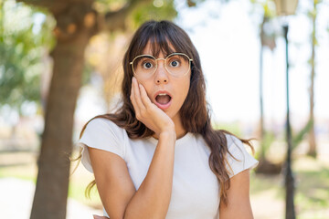 Young woman at outdoors surprised and shocked while looking right