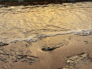 Golden hour in the reflection of the waves and the shores of the Red Sea