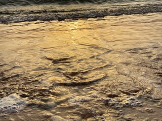 Golden hour in the reflection of the waves and the shores of the Red Sea