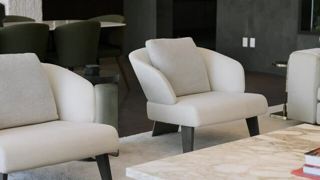 Modern living room with dark walls furnished with white design armchairs, soft couch and marble table. Luxury details in private villa