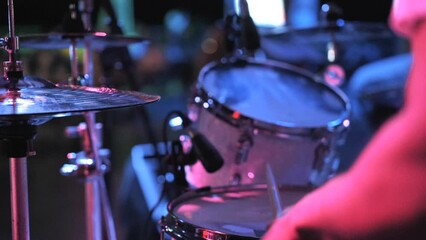 Drummer playing on stage at music festival