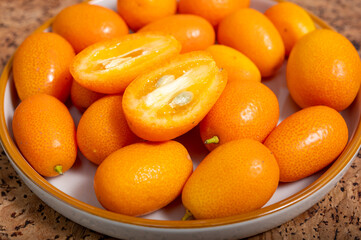 Delicious small citrus fruits orange kumquats close up