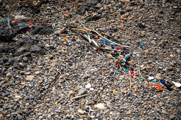 Washed up plastic waste (ocean plastic) on a beach polluting the oceans