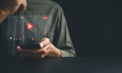 Unlock a world of entertainment with a smartphone for video streaming. Witness the fusion of technology, music, and social media as a man watches captivating content on the screen.