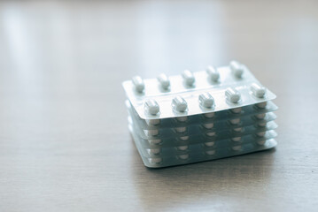 Pills, medicines, painkillers on a wooden table