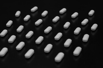 Pills, medicines, painkillers on the black table