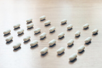 Pills, medicines, painkillers on a wooden table