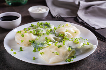 Spring rolls with cauliflower, Brussels sprouts and broccoli in rice paper on a plate