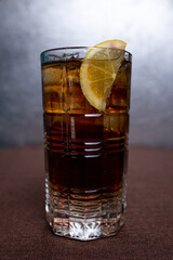 cold carbonated refreshing drink with lemon in a glass glass