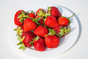 strawberries in a bowl on white background