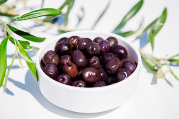 olives in a bowl on white background