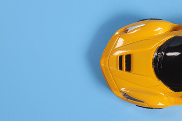Hood of a toy car on a blue background, top view. Copyspace for your text