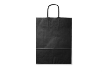 Black kraft paper shopping bag with handles isolated on a transparent background, PNG. High...