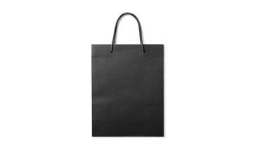Black kraft paper shopping bag with handles isolated on a transparent background, PNG. High...