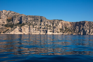 Calanques National Park near Cassis, Provence-Alpes-Côte d'Azur, France. Spectacular seascape landscape with calanques rock wall at background and its reflection in water. 