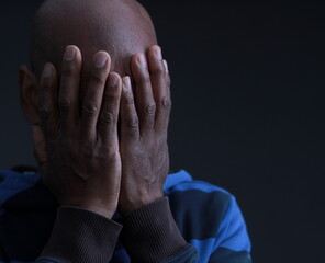 man praying to god with hands together Caribbean man praying on black background with people stock...