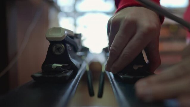 Skier checks bootstraps on skis