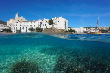 Foto op Canvas Spain, Cadaques, touristic coastal village on the shore of the Mediterranean sea with seagrass and fish underwater, split view over and under water surface, Costa Brava, Catalonia © dam