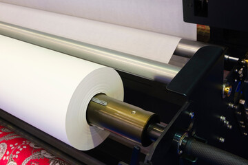 Rolls paper and fabric in wide industrial plotter