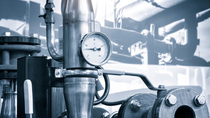 Industrial  concept. equipment of the boiler-house, - valves, tubes, pressure gauges, thermometer. Close up of manometer, pipe, flow meter, water pumps and valves of heating system in a boiler room.