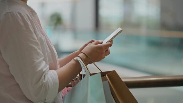 Online Shopping, Fashionable Young Woman Working With Touch Smartphone Holding A Phone In A Supermarket, Fashion Savvy Woman Shopping In A Fashion Store Staying Beautiful At Any Time, Window Shopping
