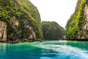 Boats in the Pileh Lagoon, turquoise and greenish paradisiacal waters in Thailand.
