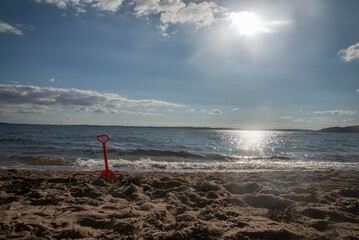 Fototapeta na wymiar Toy Spade left on the beach