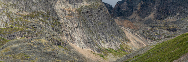 Panoramic mountain wilderness seen arctic Canada during summer time in Tombstone Territorial Park on Grizzly Lake hike expansive wild views panorama.