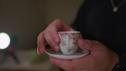 Close-up hand serving coffee to friend, sharing warm beverage