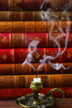 Smoking Candle And Antique Books