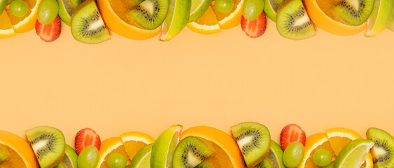 Summer fruits banner with citrus and strawberries with copy space on colored background. Flat lay, top view.