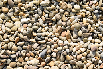 Pebble stones on the ground with different surface color and structure pattern