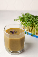 Microgreens smoothie as a snack for healthy eating. Close up, copy space for text