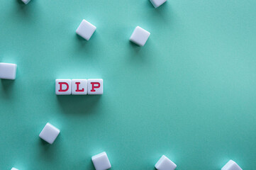 There is notebook with the word DLP. It is an abbreviation for Data Loss Prevention as eye-catching image.