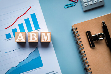 There is wood cube with the word ABM. It is an abbreviation for Account Based Marketing as...