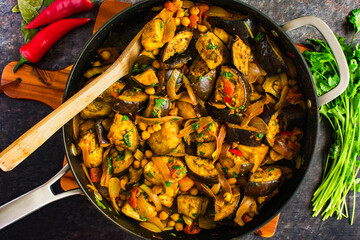 Vegan Roasted Eggplant and Chickpea Curry Served in a Skillet: Aubergine curry with garbanzo beans,...