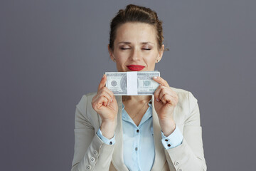 smiling trendy woman worker in light business suit